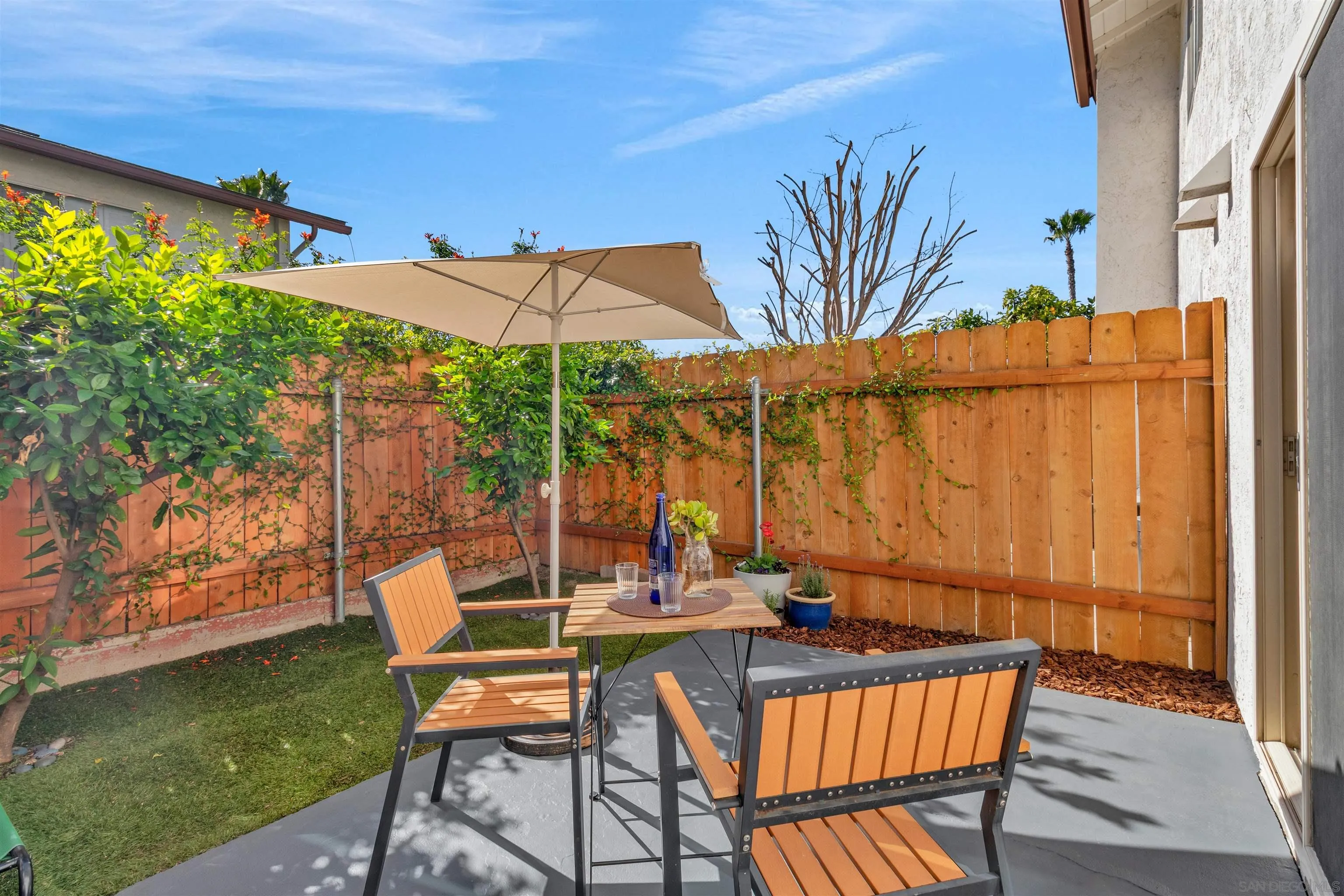 an outdoor sitting area with furniture and wooden deck