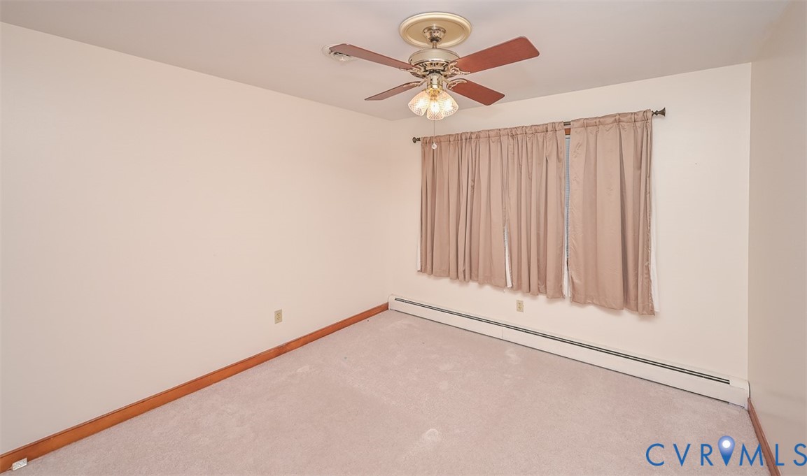 1629 New Market Road Henrico, VA 23231 - Photo 23 of 49 an empty room with a chandelier fan and windows