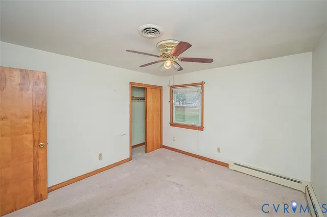 an empty room with a window and a ceiling fan