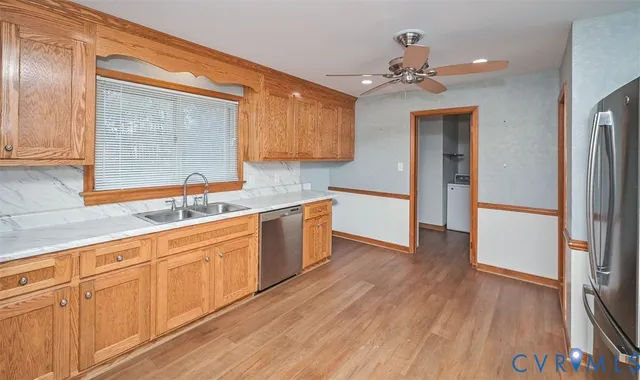 a kitchen with a sink cabinets and window