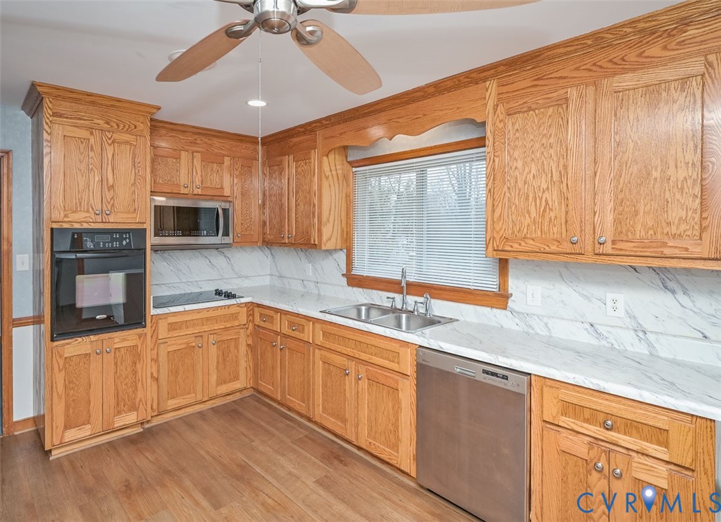 1629 New Market Road Henrico, VA 23231 - Photo 36 of 49 a kitchen with stainless steel appliances granite countertop a sink stove and microwave