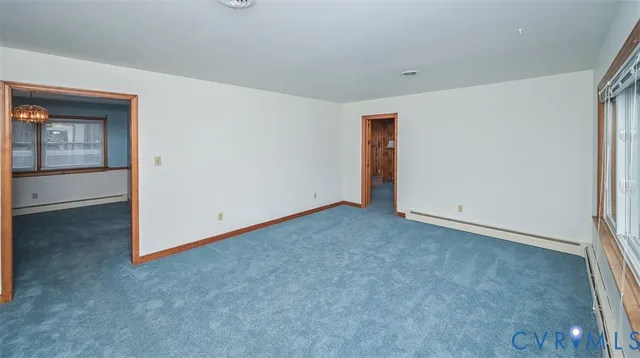 an empty room with windows lake and mountain view