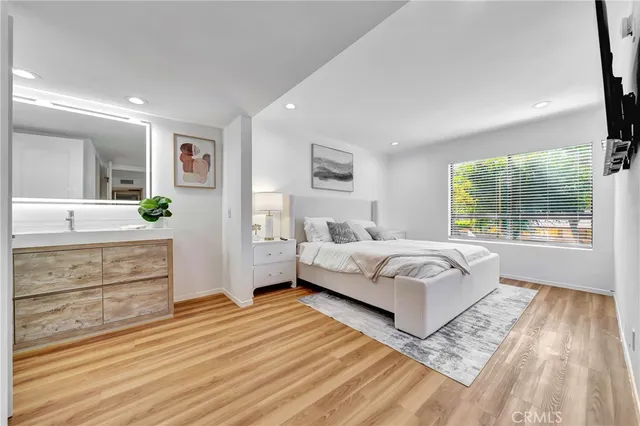 a spacious bedroom with a large bed and a dresser