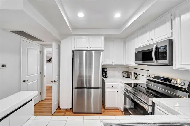 a kitchen with stainless steel appliances a refrigerator a stove and a microwave
