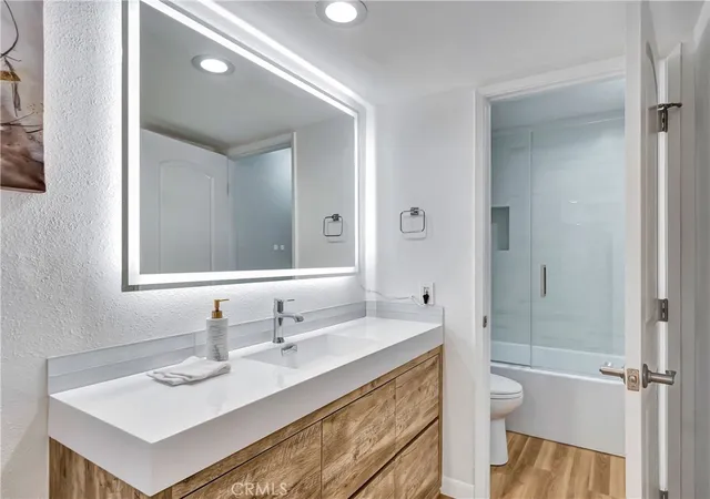 a bedroom with a bed and a large mirror