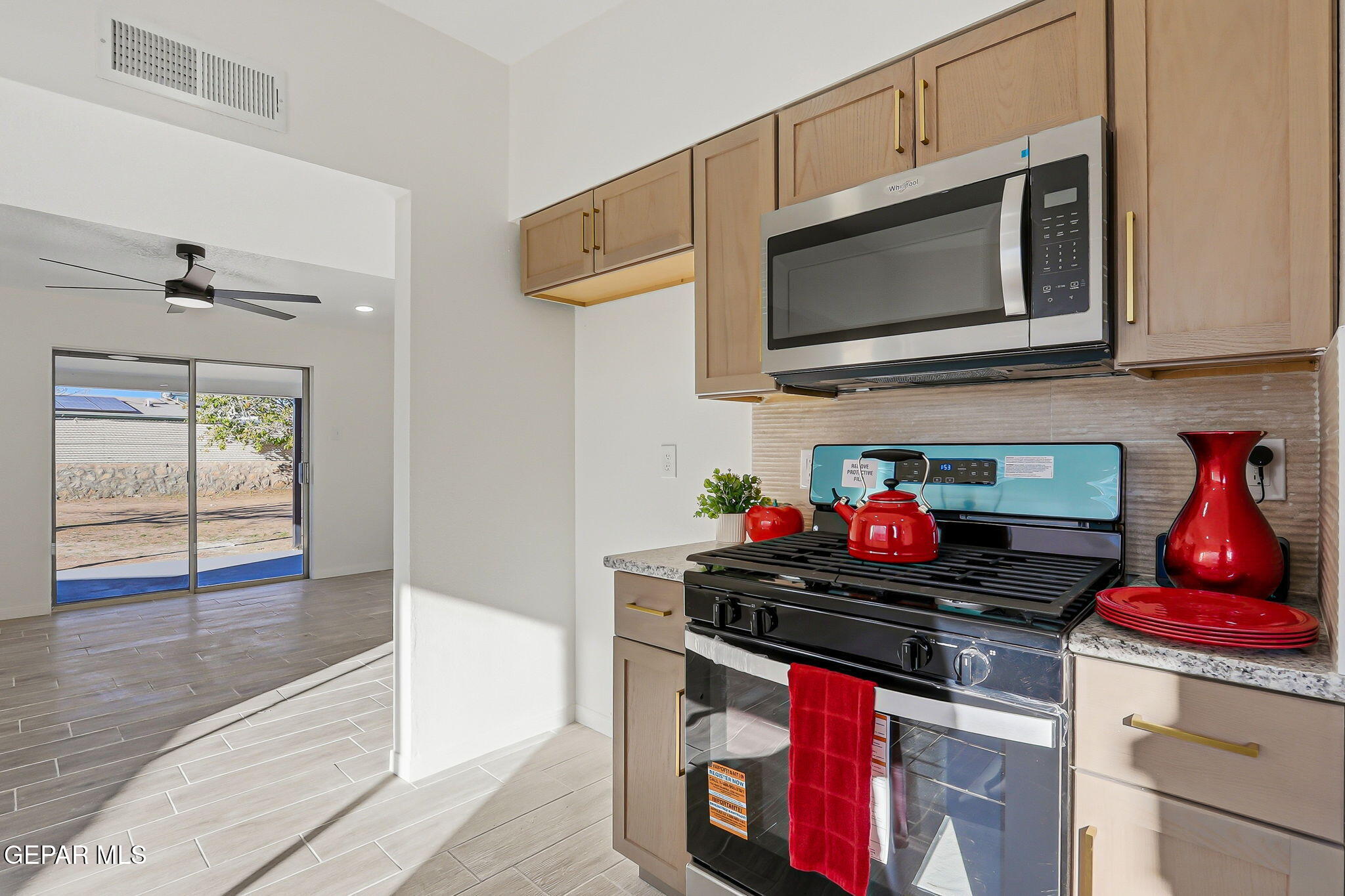 113 West Point Drive El Paso, TX 79907 - Photo 11 of 40 a kitchen with a stove and a microwave