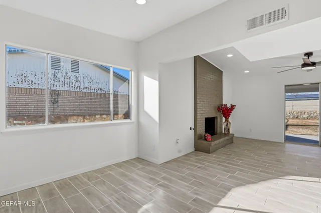 a living room with furniture a rug and a fireplace