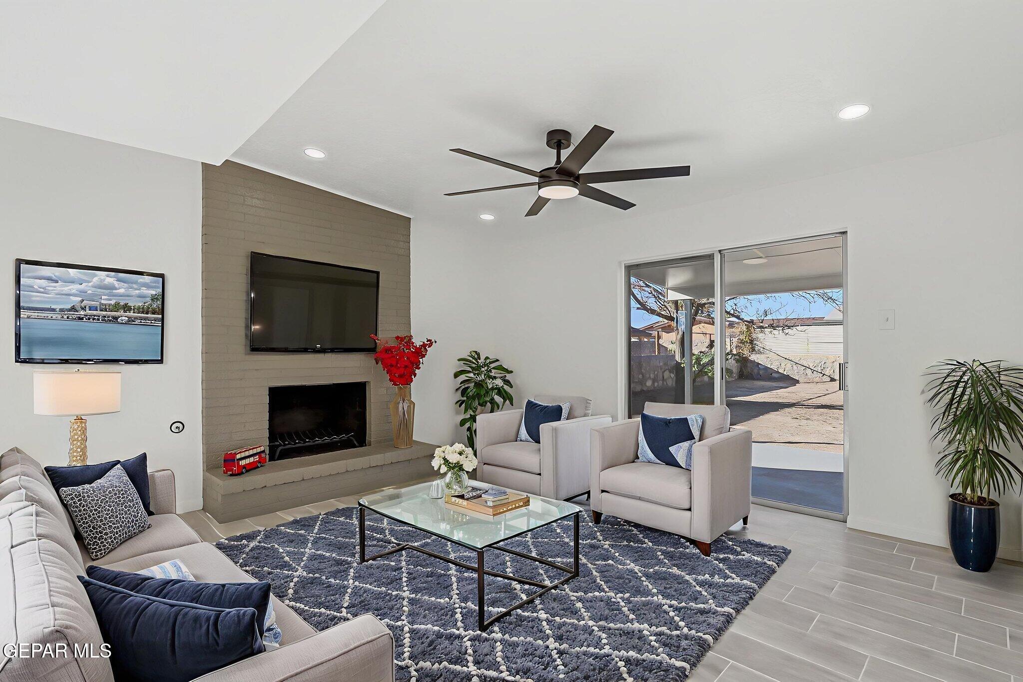113 West Point Drive El Paso, TX 79907 - Photo 7 of 40 a living room with furniture a rug and a fireplace