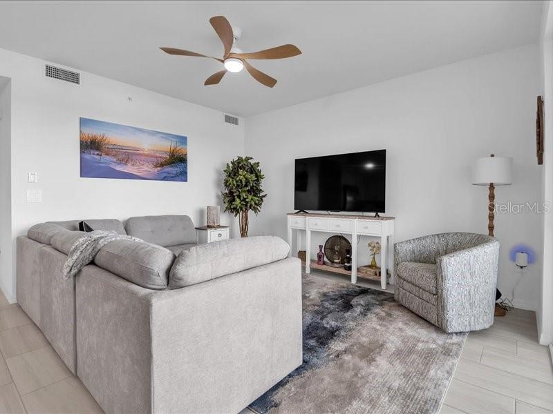 19116 Scallop Loop, Unit 303 Lakewood Ranch, FL 34211 - Photo 16 of 32 a living room with furniture and a flat screen tv