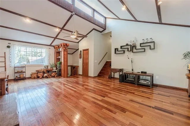 a view of a room with wooden floor and furniture