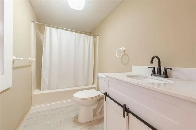 a view of room with window and wooden floor