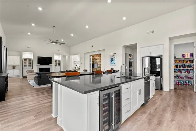 a kitchen with a table chairs a sink dishwasher stove and wooden floor