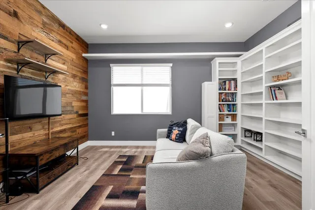 a living room with furniture and view of kitchen