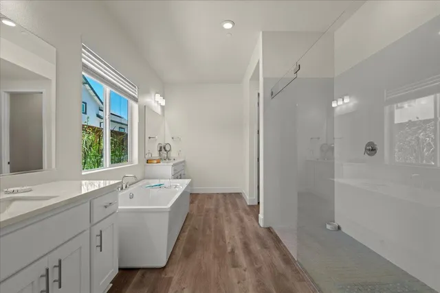 a bathroom with a bathtub a sink and a shower