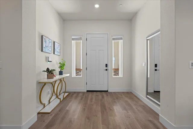 a living room with furniture wooden floor and a flat screen tv