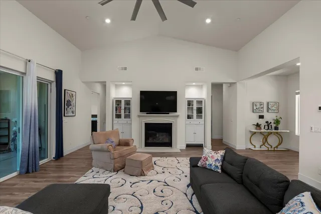 a living room with furniture a fireplace and a flat screen tv