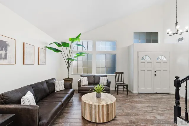 a living room with furniture and a potted plant