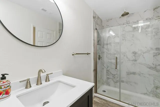 a spacious bedroom with a bed and a flat screen tv