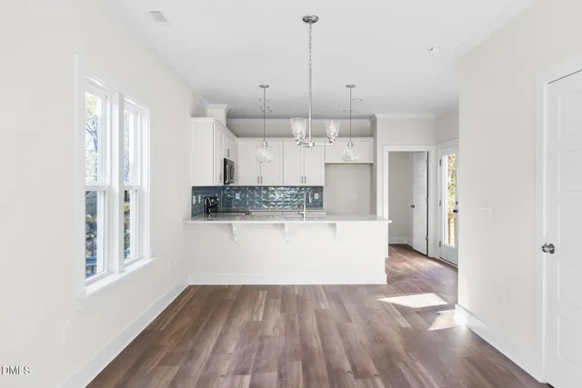 a view of kitchen with wooden floor window and refrigerator
