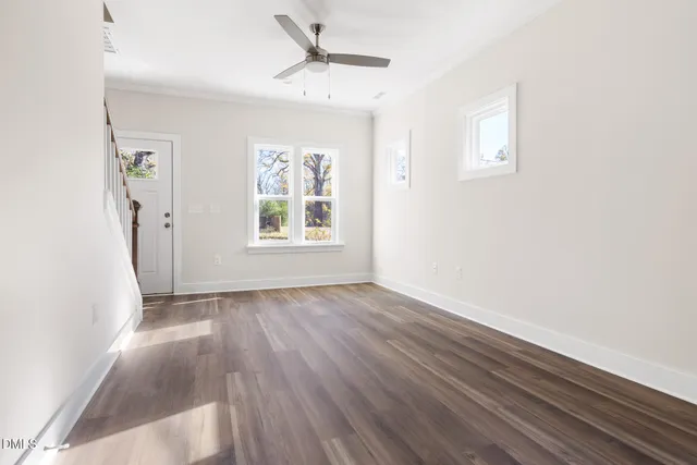 wooden floor in an empty room with a window