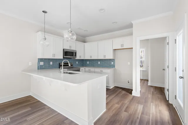 a view of a kitchen with electric appliances