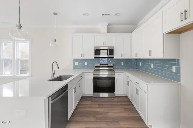 a kitchen with stainless steel appliances granite countertop a sink and a stove