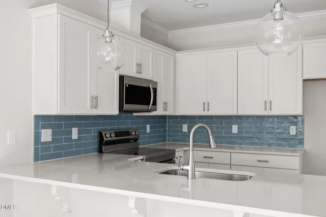 a kitchen with stainless steel appliances granite countertop a sink and a microwave