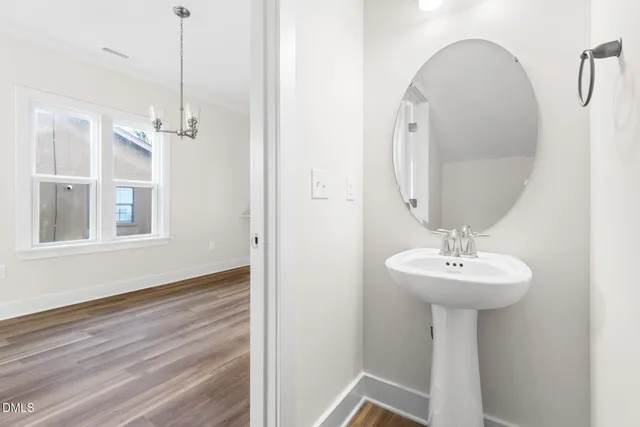 a bathroom with a sink a mirror and shower