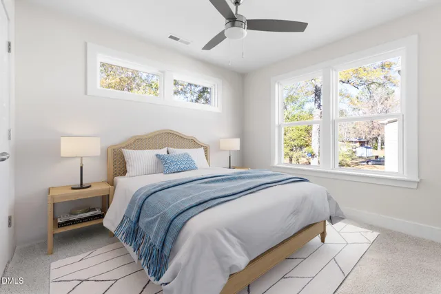 a bedroom with a bed and a painting on the wall