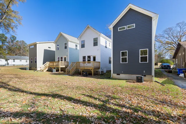 a front view of a house with a yard covered with snow