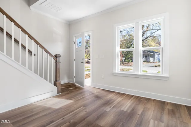a view of entryway with wooden floor and stairs