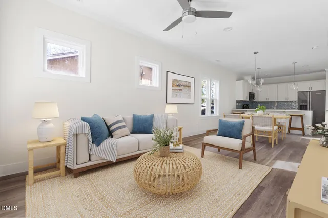 a living room with furniture and a wooden floor