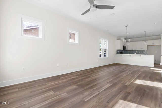 a view of a kitchen with a microwave and wooden floor