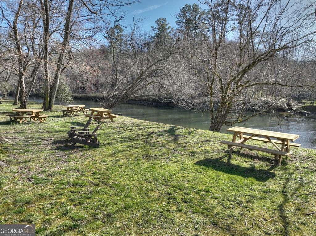 112 Fawn Way Mineral Bluff, GA 30559 - Photo 26 of 26 a view of a lake with a bench and trees around