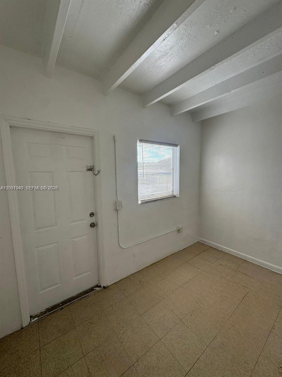 320 Southwest 11th Avenue, Unit 2 Homestead, FL 33030 - Photo 7 of 11 an empty room with a workbench