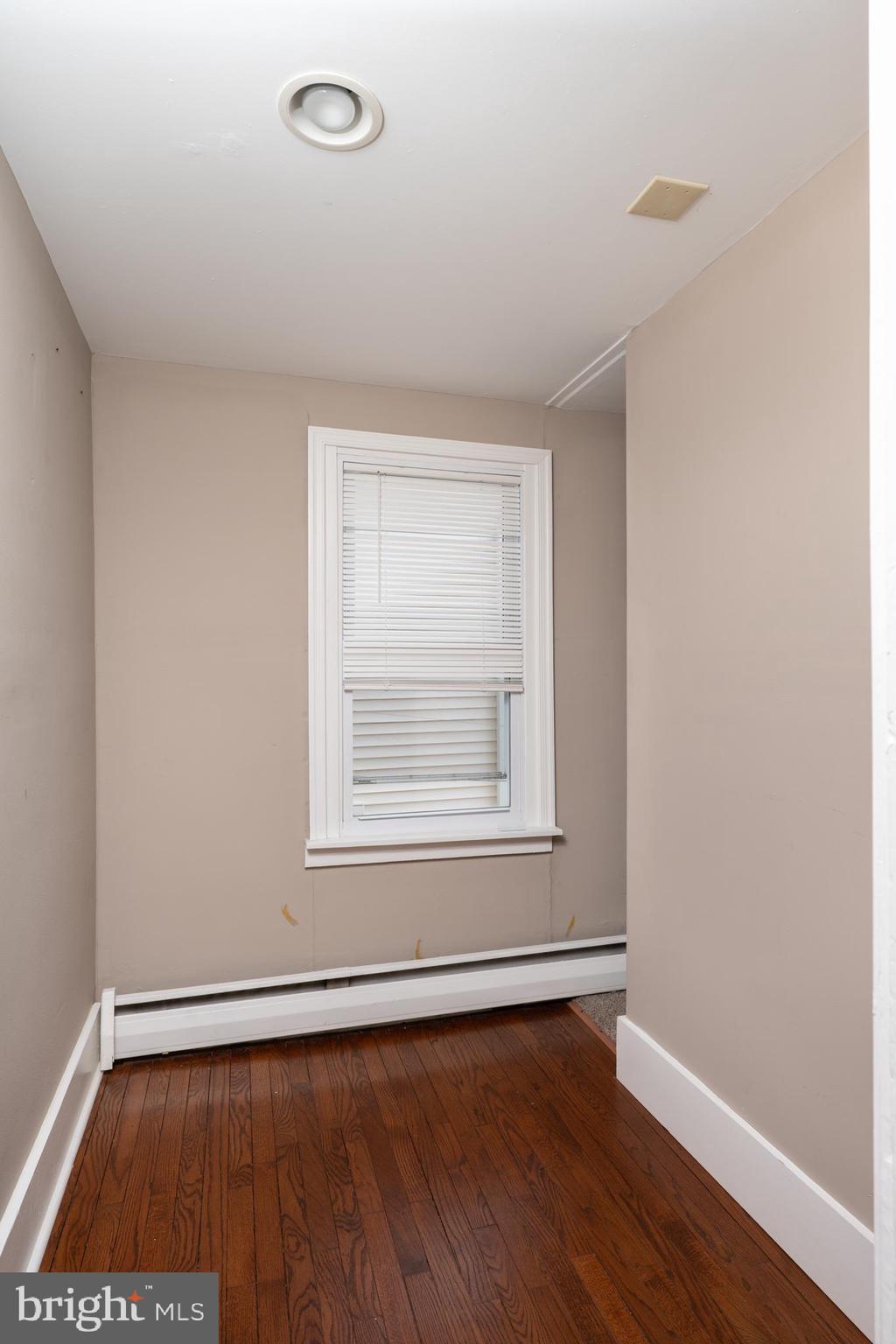 308 Summer St Road Royersford, PA 19468 - Photo 14 of 25 an empty room with wooden floor and windows
