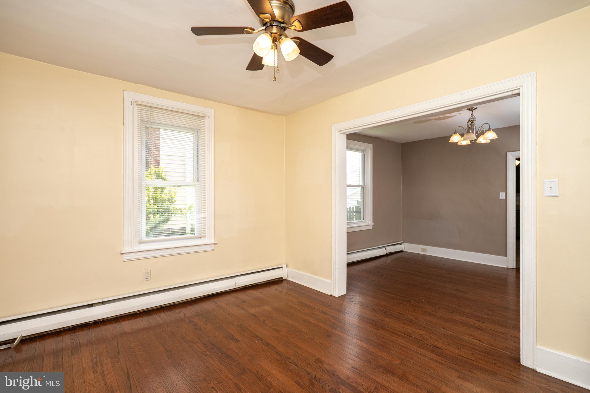 308 Summer St Road Royersford, PA 19468 - Photo 2 of 25 an empty room with wooden floor chandelier fan and windows