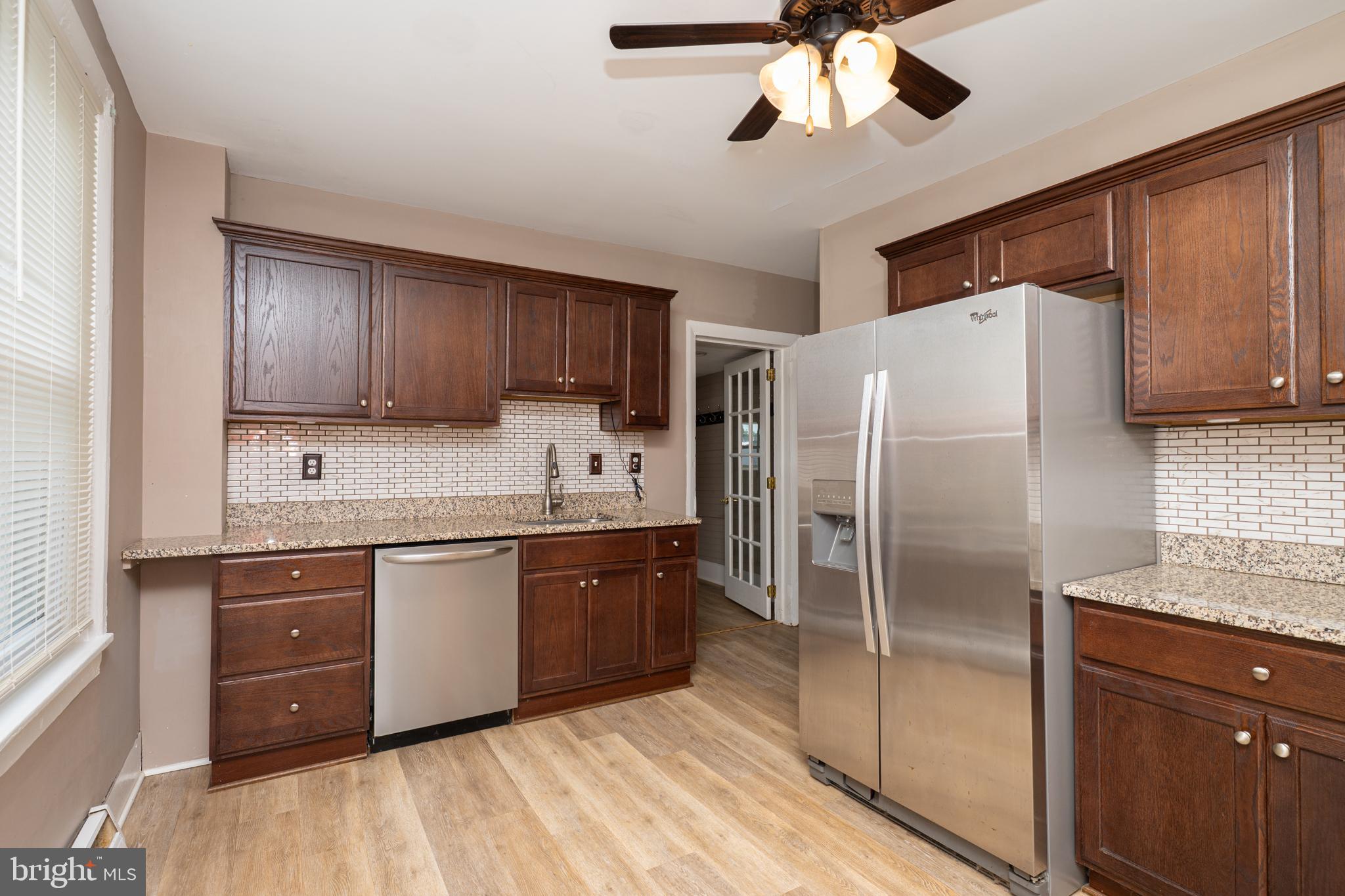 308 Summer St Road Royersford, PA 19468 - Photo 6 of 25 a kitchen with stainless steel appliances granite countertop a refrigerator a sink dishwasher a stove with wooden cabinets and floor