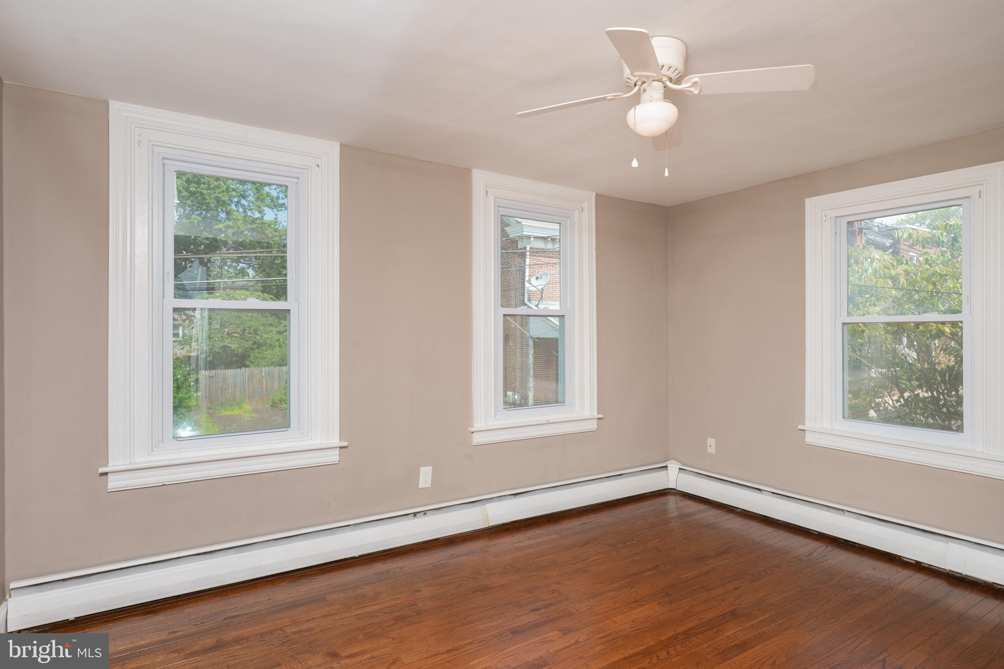 308 Summer St Road Royersford, PA 19468 - Photo 9 of 25 a view of an empty room with wooden floor and a window