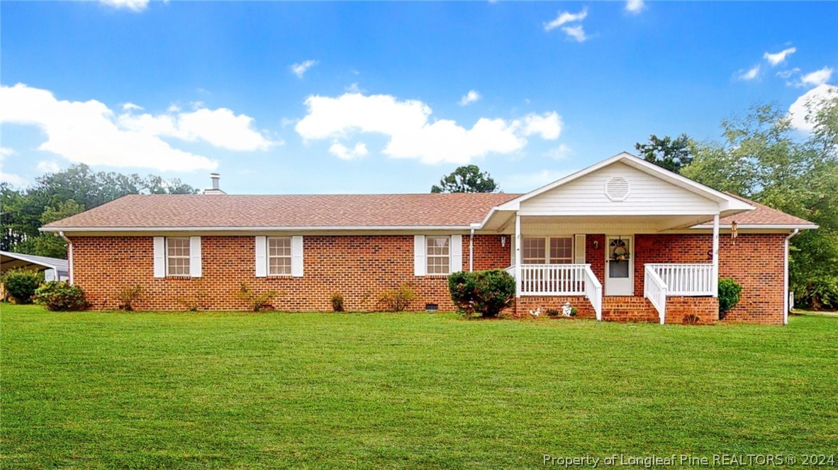 1340 Roseland Road Aberdeen, NC 28315 - Photo 1 of 39 a front view of a house with a yard and porch