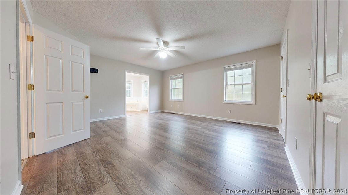 1340 Roseland Road Aberdeen, NC 28315 - Photo 15 of 39 a view of an empty room with a window and wooden floor