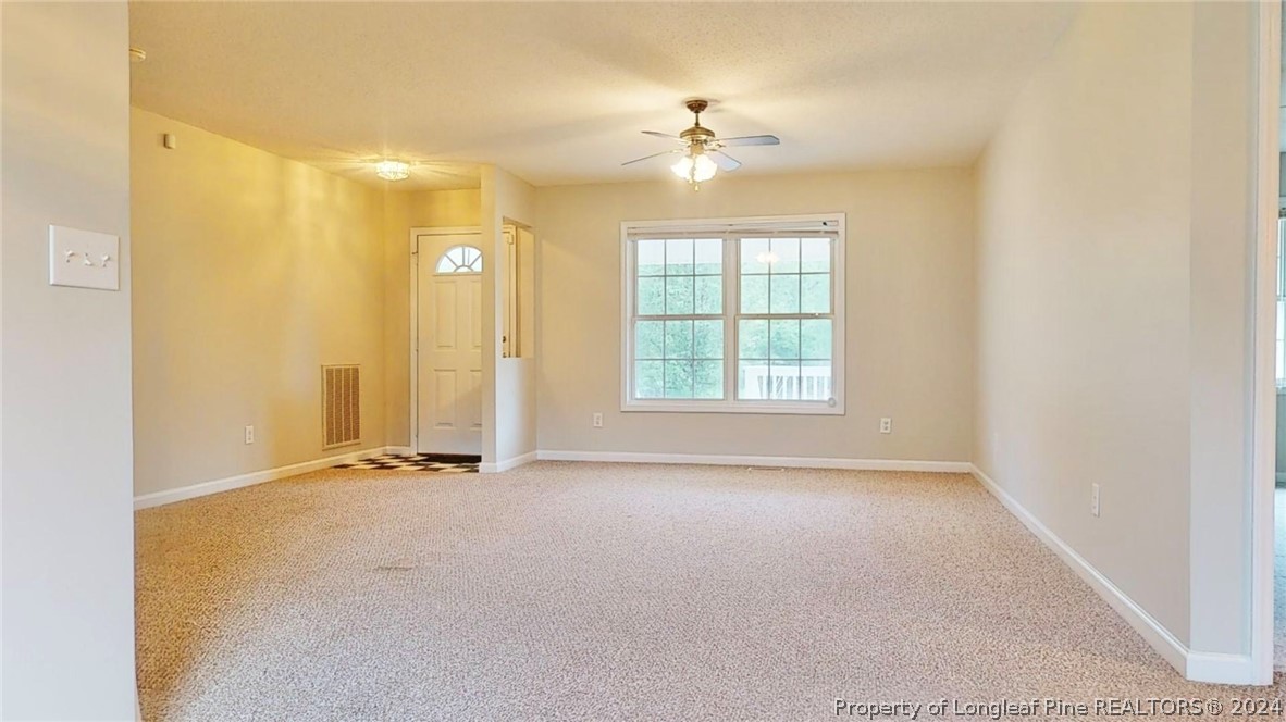 1340 Roseland Road Aberdeen, NC 28315 - Photo 5 of 39 an empty room with chandelier fan