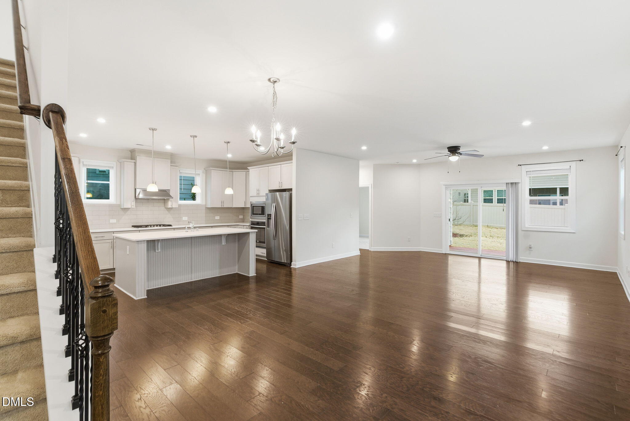 2913 Macbeth Lane Apex, NC 27502 - Photo 10 of 62 a large white kitchen with a refrigerator a sink dishwasher and a stove with wooden floor