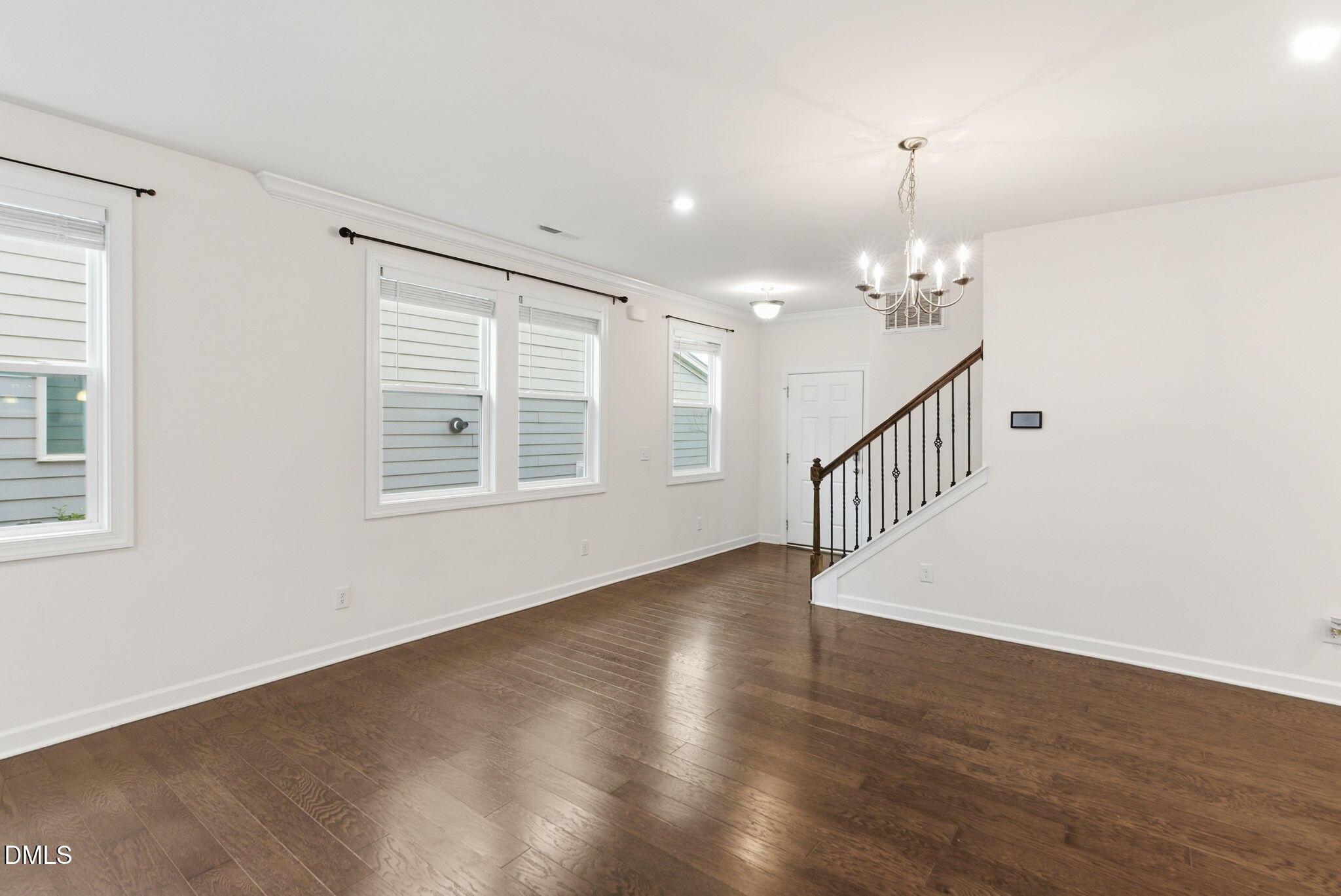 2913 Macbeth Lane Apex, NC 27502 - Photo 12 of 62 a view of an empty room with wooden floor and a window