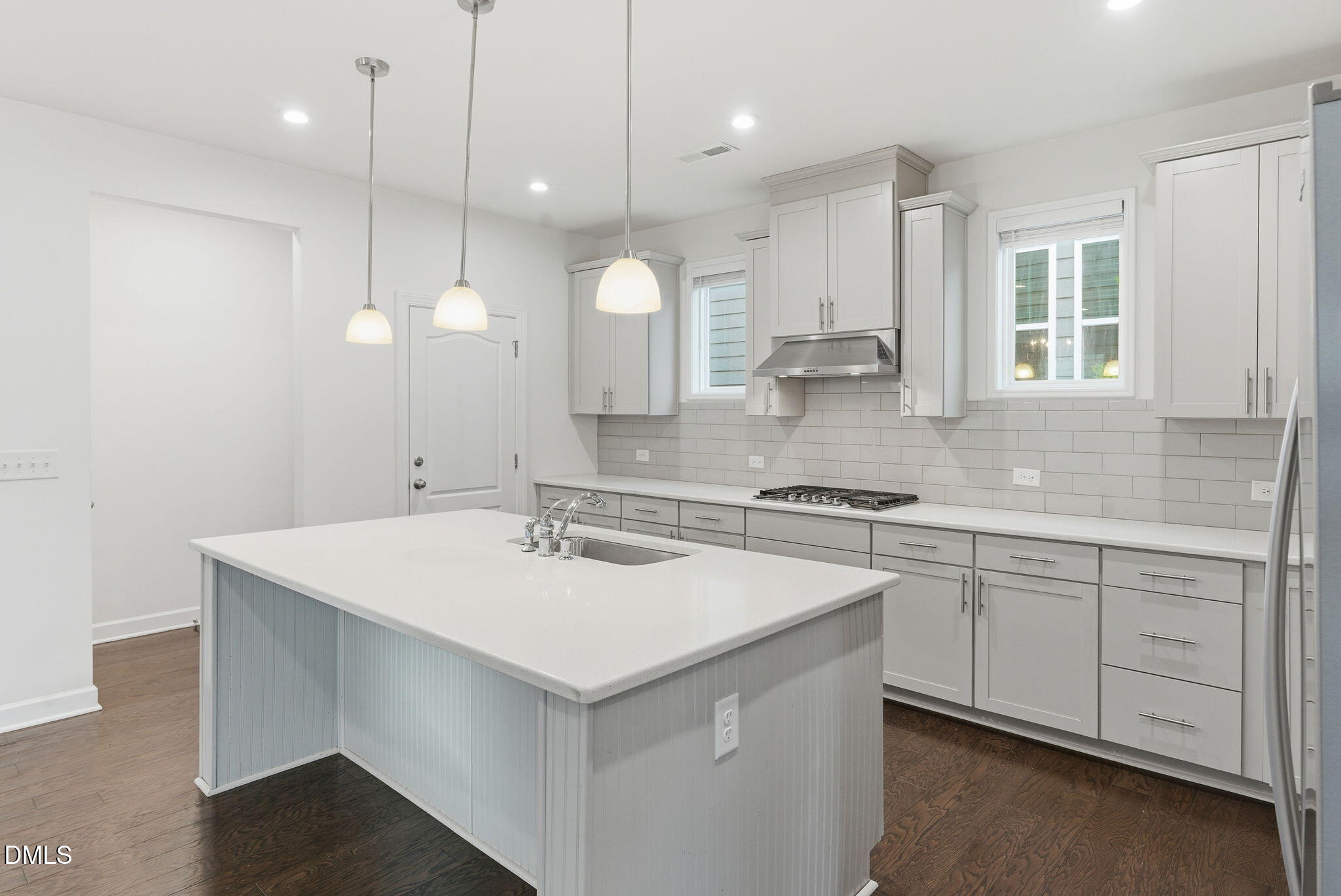 2913 Macbeth Lane Apex, NC 27502 - Photo 16 of 62 a kitchen with a sink a stove a counter space and cabinets