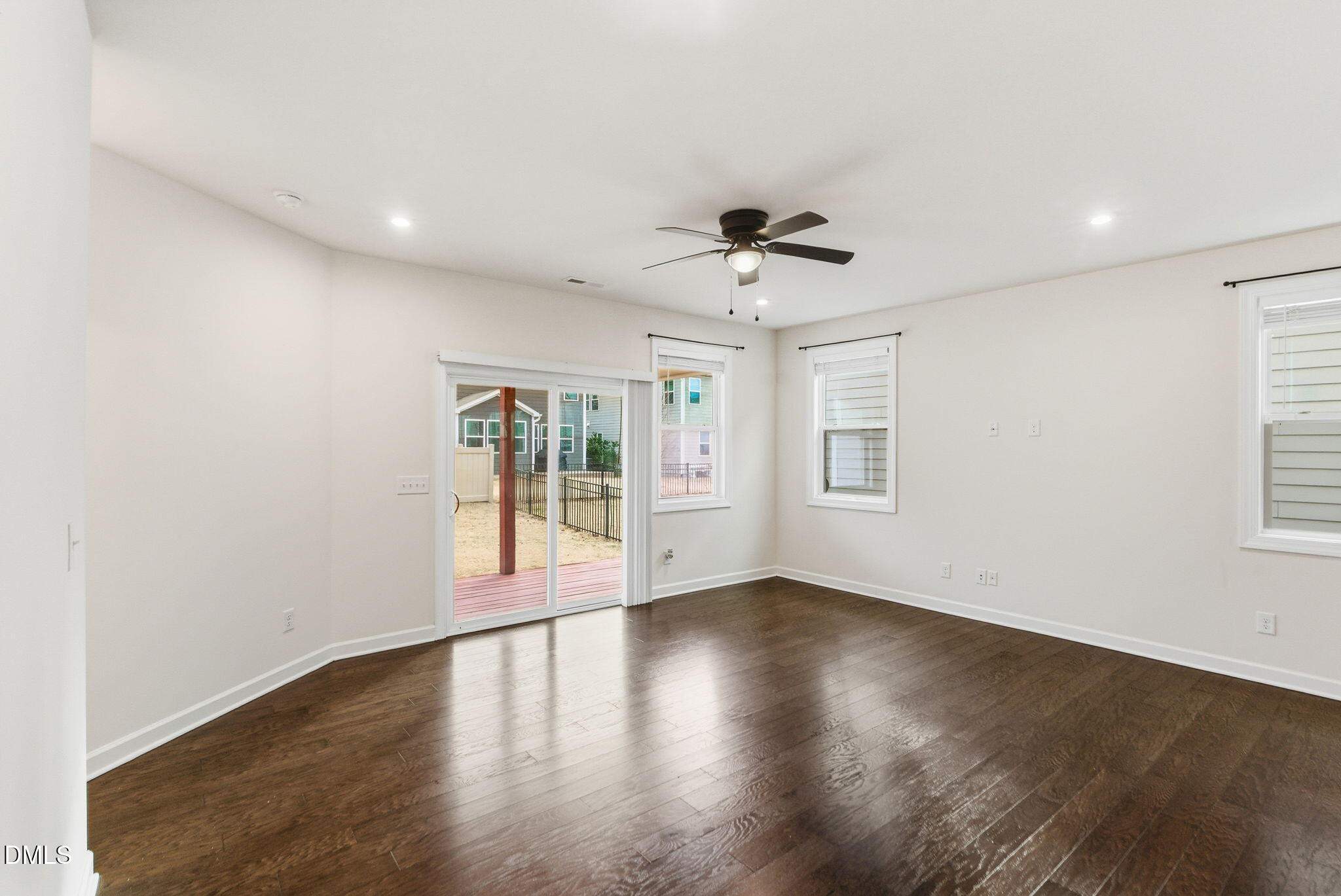 2913 Macbeth Lane Apex, NC 27502 - Photo 23 of 62 a view of an empty room with a window and wooden floor