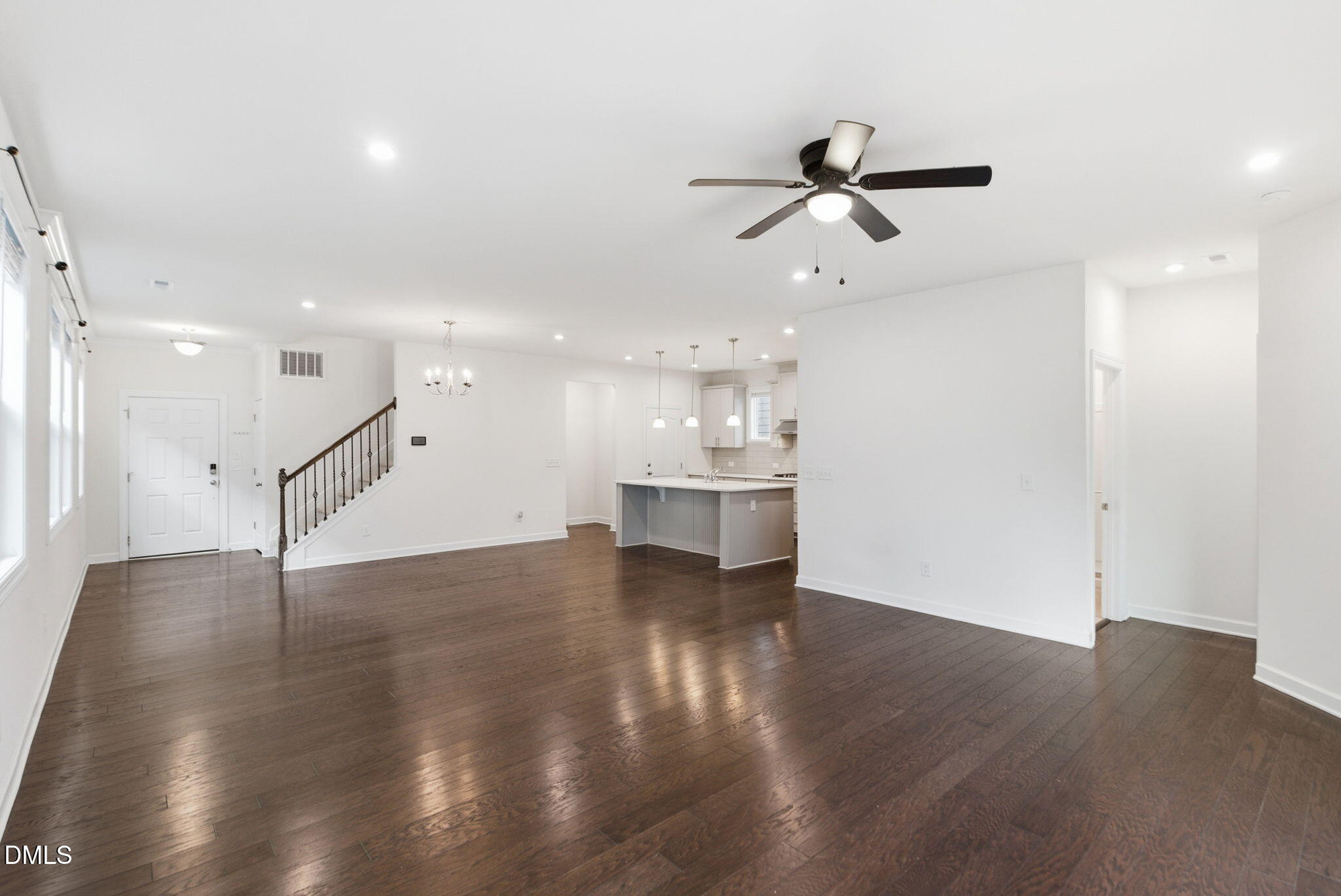 2913 Macbeth Lane Apex, NC 27502 - Photo 24 of 62 a view of an empty room with wooden floor and a ceiling fan