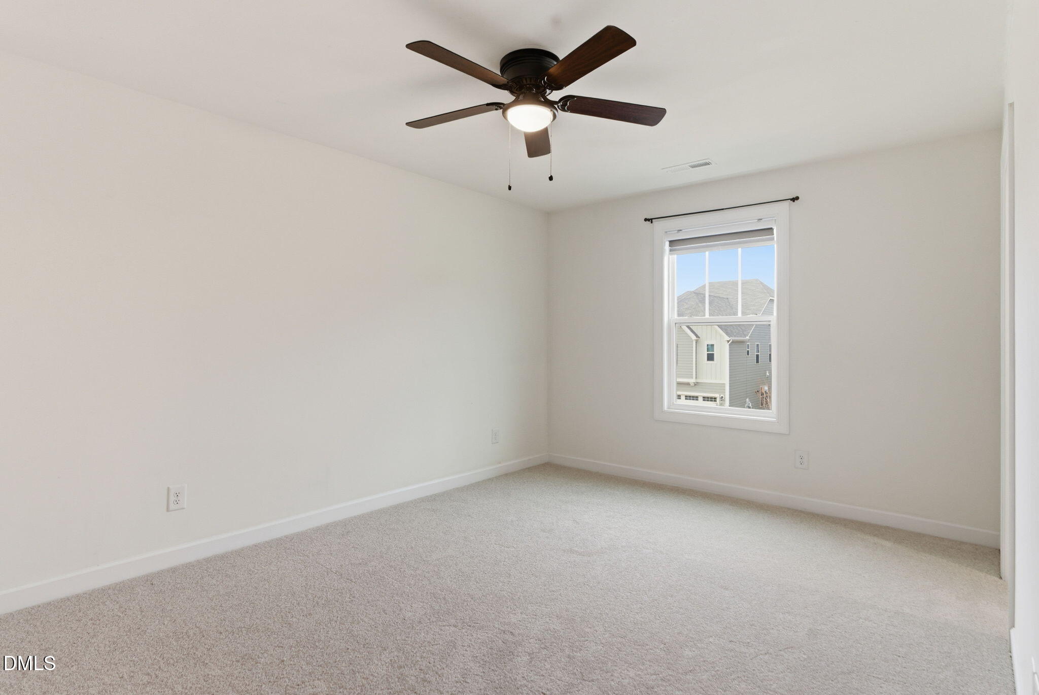 2913 Macbeth Lane Apex, NC 27502 - Photo 32 of 62 an empty room with a window and a ceiling fan