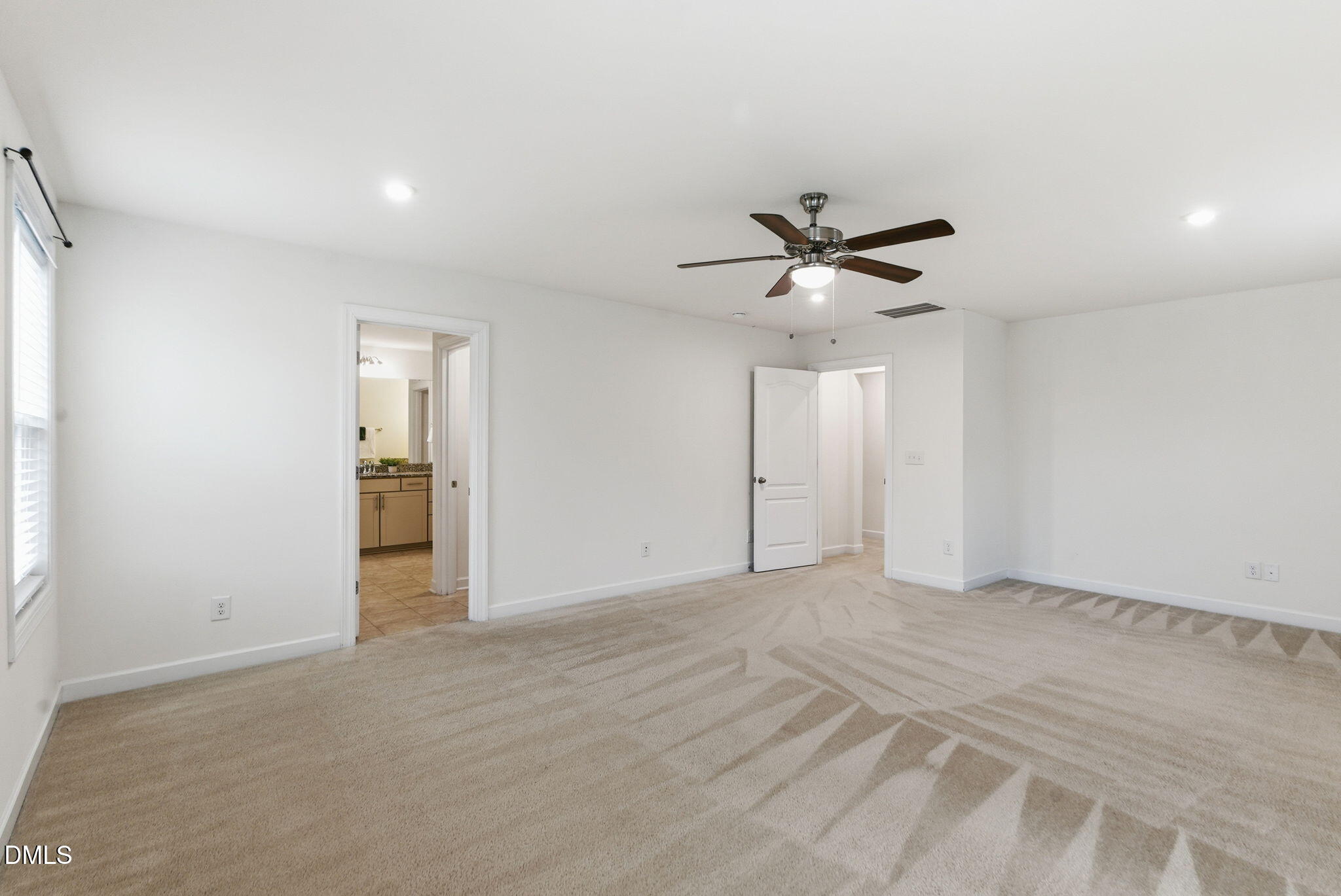 2913 Macbeth Lane Apex, NC 27502 - Photo 41 of 62 an empty room with closet and ceiling fan