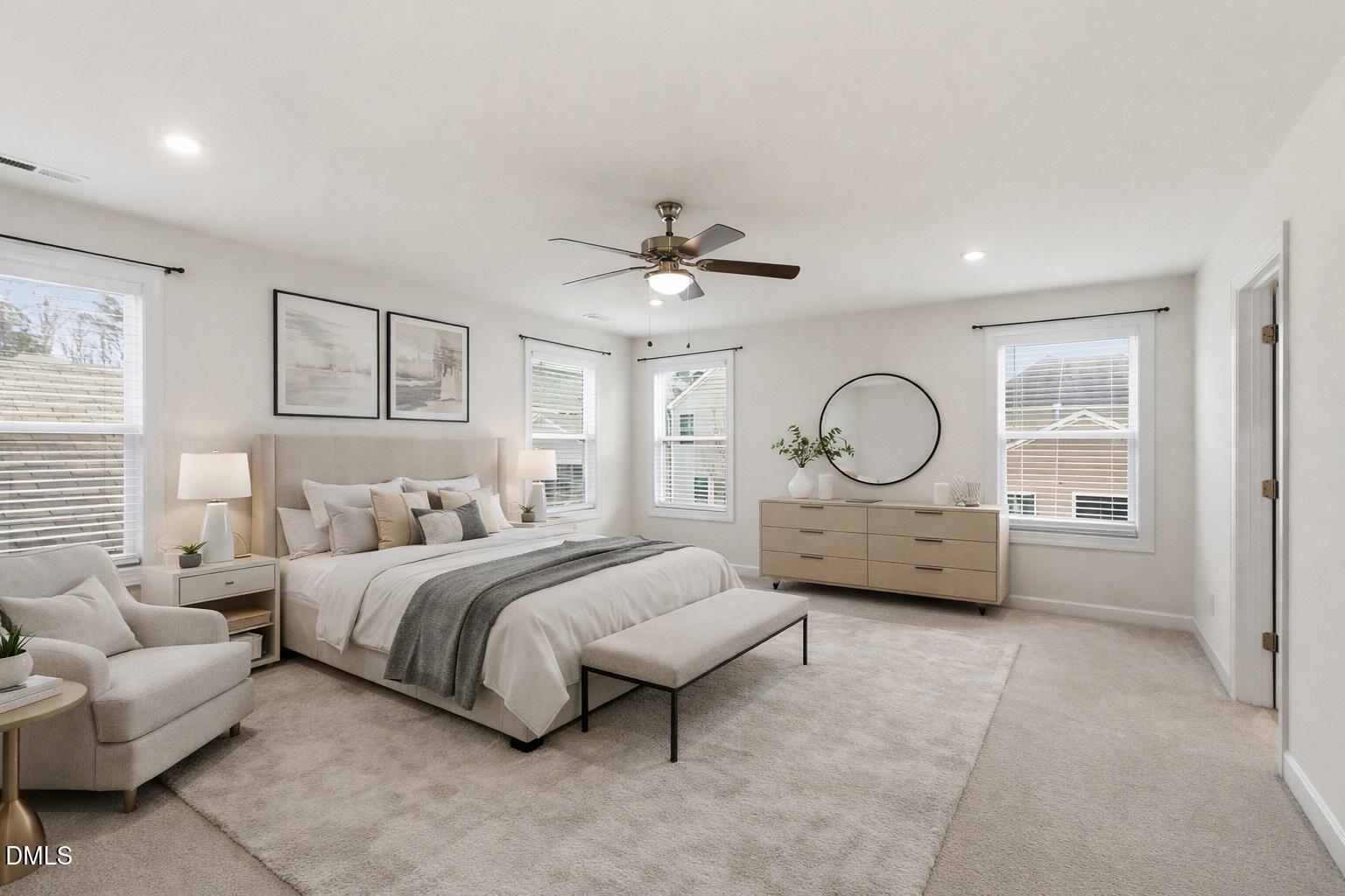 2913 Macbeth Lane Apex, NC 27502 - Photo 43 of 62 a spacious bedroom with a bed large window and a chandelier